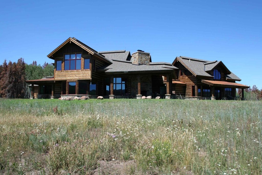 Long low-slung mountain home with dark metal roof