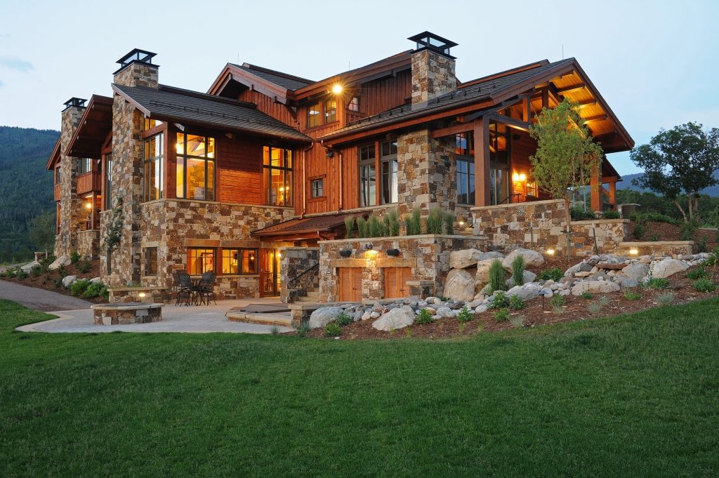 Large stone and cedar residence on a green hillside